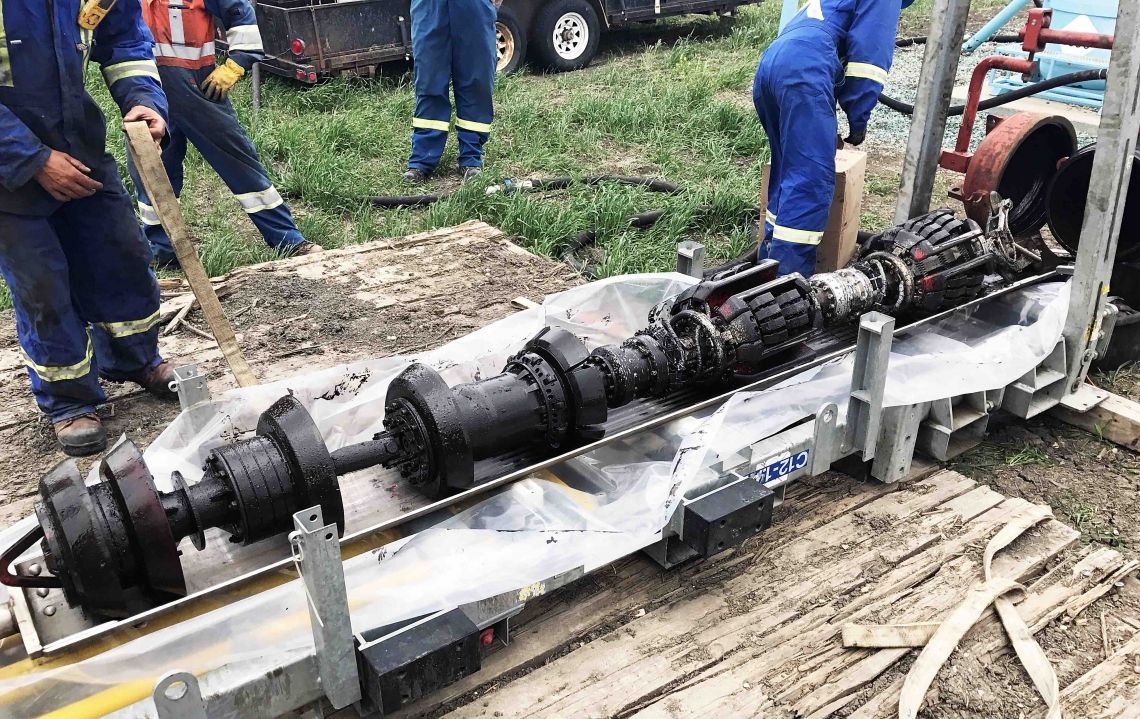 TransGas employees working on a pipeline maintenance tool