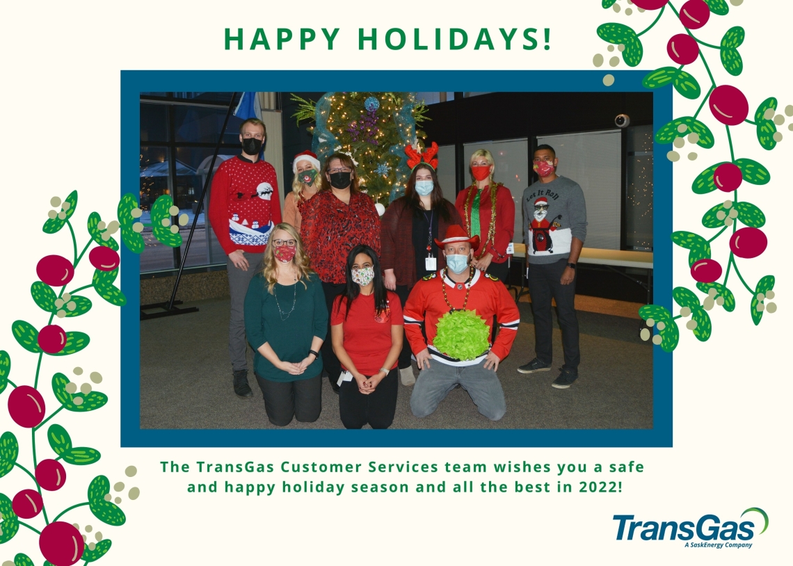 TransGas Customer Services team dressed in Christmas sweaters and standing or sitting in front of a decorated tree
