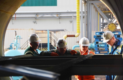 TransGas Employees inspect pipe